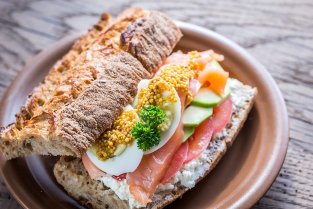 Sandwich with salmon, avocado and eggs