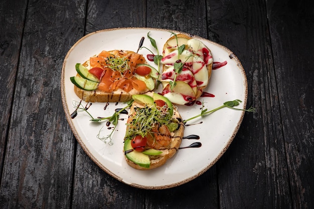 sandwich with salmon, avocado, tomato and cheese. healthy breakfast.