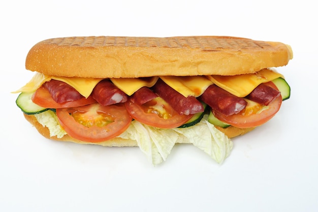 Sandwich with sausage, tomato, cucumber, cheese and lettuce on a white background