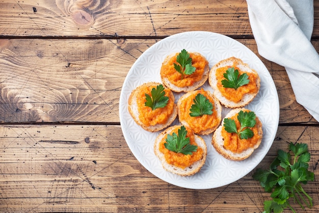 Sandwiches with bread zucchini caviar tomatoes onions. Homemade vegetarian food. Canned stewed vegetable. wooden background top view, copy space