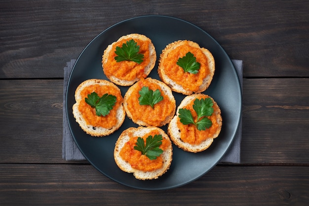 Sandwiches with bread zucchini caviar tomatoes onions. Homemade vegetarian food. Canned stewed vegetable. wooden background top view, copy space