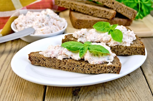 Sandwiches with cream of salmon and mayonnaise on the board