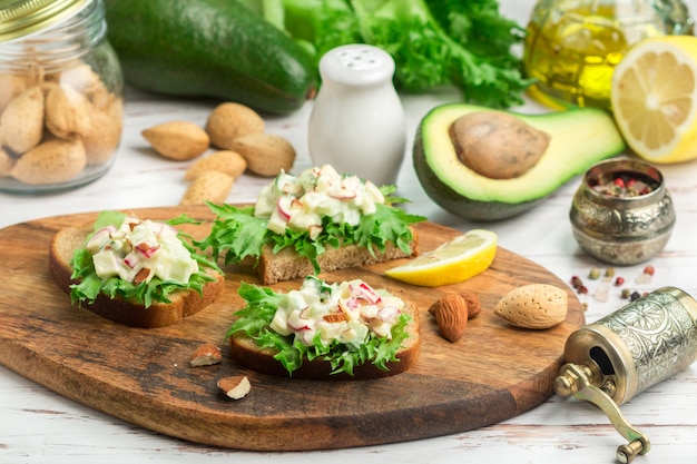 Sandwiches with lettuce and salad of eggs, radishes, cucumbers and avocado with homemade mayonnaise 