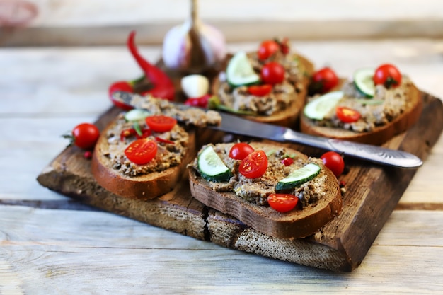 Sandwiches with pate and cherry tomatoes.