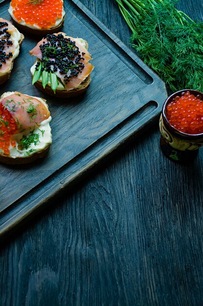 Sandwiches with red and black caviar. 