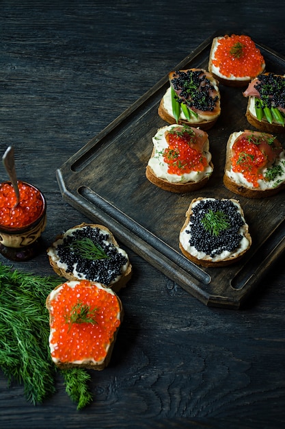 Sandwiches with red and black caviar. 