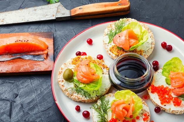 Sandwiches with salmon, red caviar and cream cheese