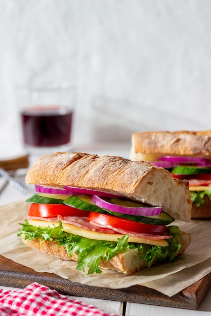 Sandwiches with sausage, cheese and green salad