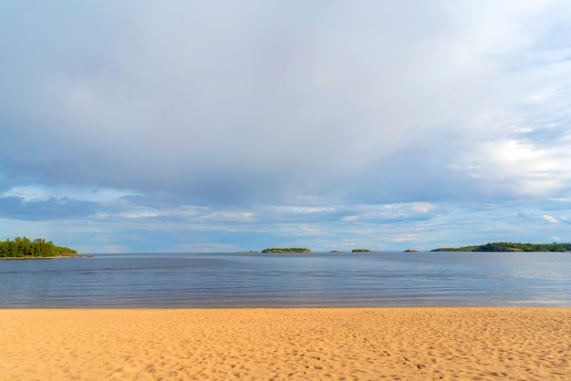 Sandy beach on the shore of a clean lake.