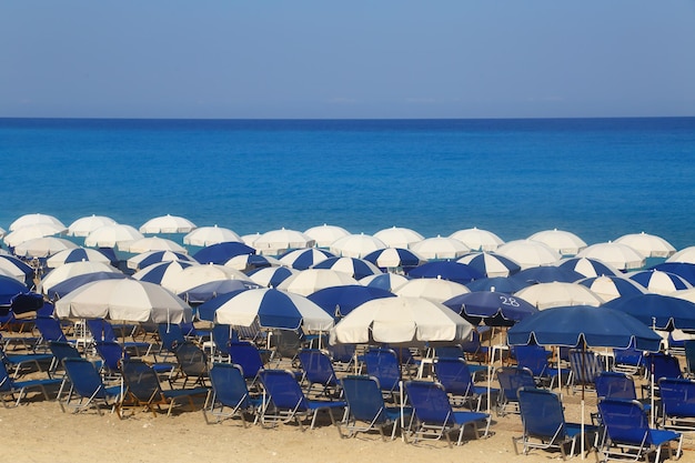 Sandy beach with white parasols and sunbeds Kathisma Lefkada