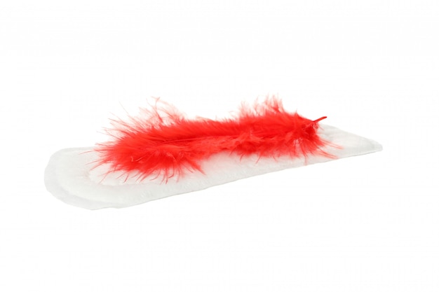 Sanitary pad with red feather isolated on white surface