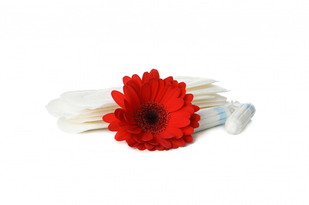 Sanitary pads, tampons and gerbera isolated on white surface