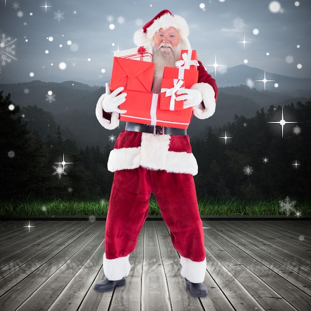 Santa carrying gifts against wooden planks against mountains