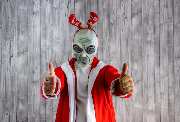 Santa Claus in alien costume with the thumbs up