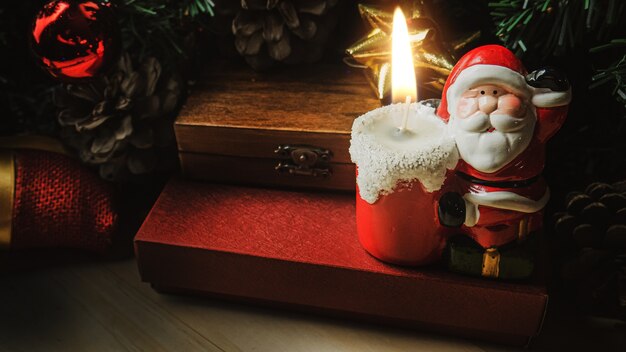 The Santa Claus candle on wood table for Christmas  content.