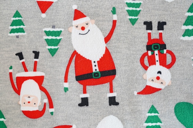 santa claus and chrismas tree on fabric textur