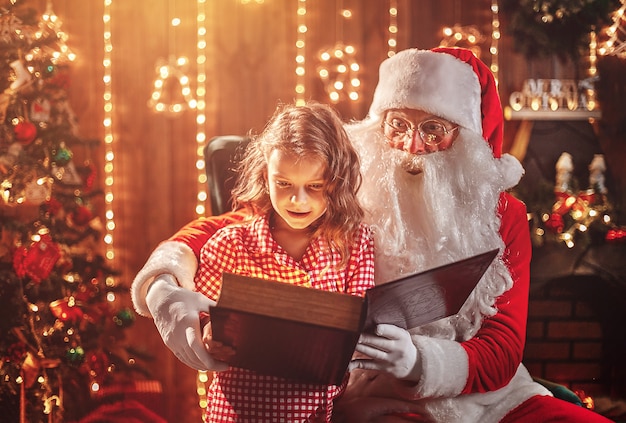 Santa Claus giving a present to a little cute girl