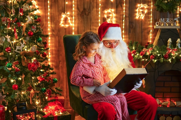 Santa Claus giving a present to a little cute girl