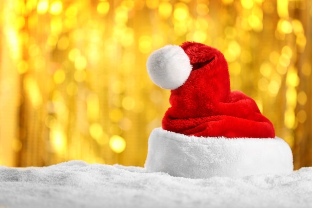 Santa Claus hat on blurred golden lights background