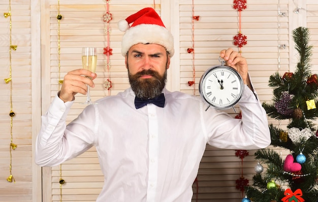 Santa Claus in hat with confused face in festive room