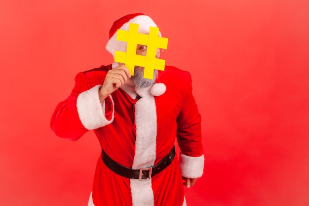 Photo santa claus hiding face behind hashtag symbol, popular blogger recommending to follow tag, comments.