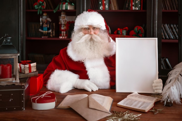 Santa Claus holding white frame in his hands