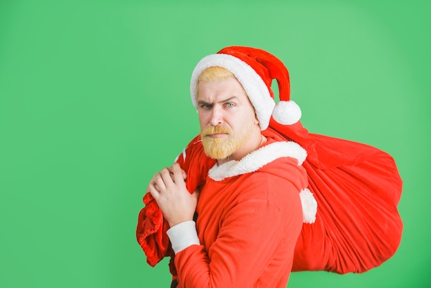 Santa claus holds present bag santa claus with gifts new year gifts merry christmas santa claus