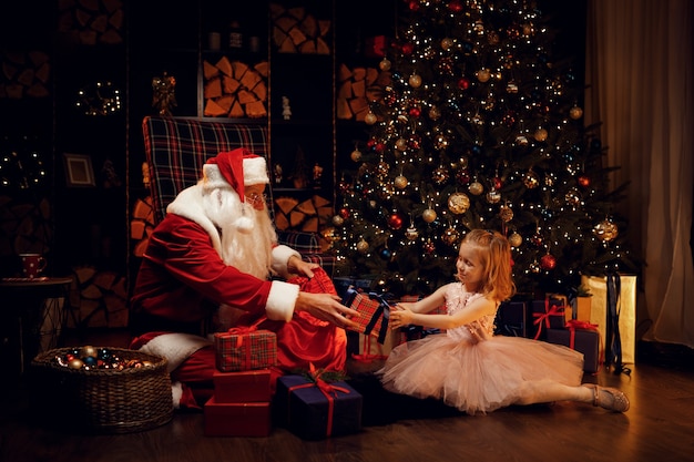 Santa Claus and little girl on christmas day