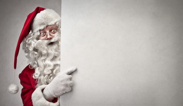 Santa Claus pointing on a board