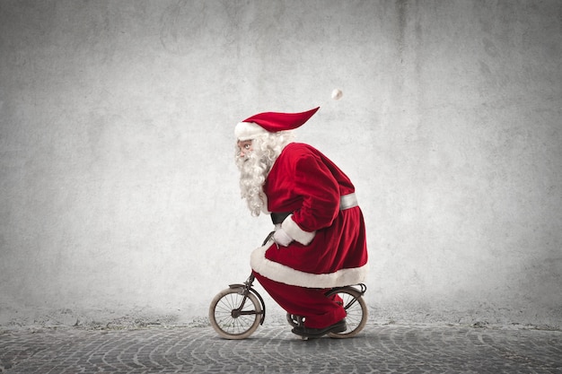 Santa Claus riding a tiny bike