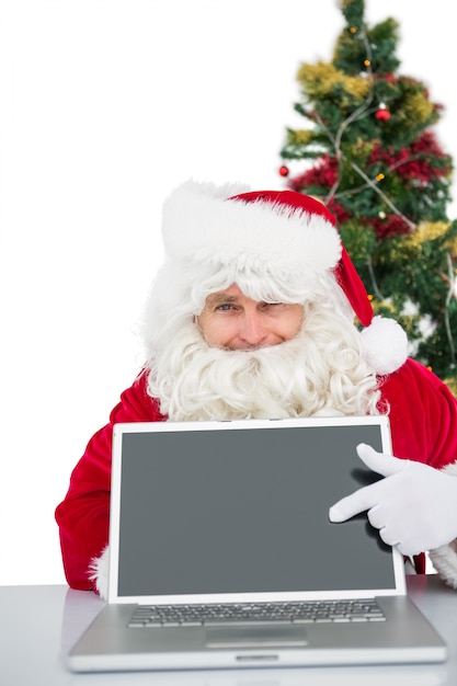 Santa claus showing his laptop 