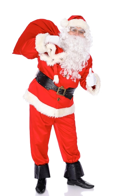 Santa Claus standing with his sack full of presents isolated on white background Full length portrait