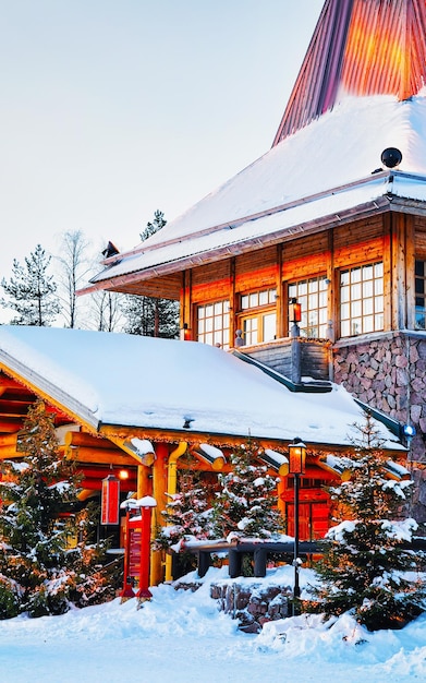 Santa Claus village at Rovaniemi of Finland Lapland. Christmas office house winter. Laponia and snow. Travel to Joulupukki at Holiday park on north pole. New year.  Post with lights. Tree decoration