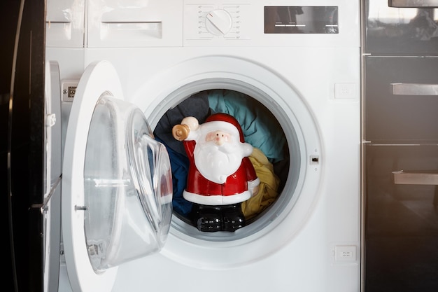 Santa Claus in the washing machine. Christmas.