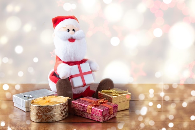 Santa Claus with gifts and blurred background with lights