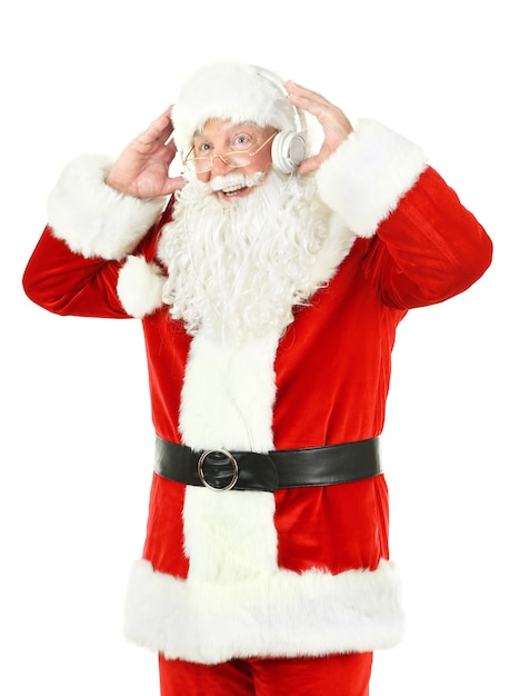 Santa Claus with headphones listening to music, isolated on white wall