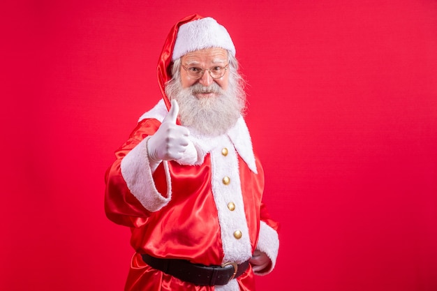 Santa Claus with his thumb up making a thumbs up. Christmas night. Gift delivery. Children's enchanted dreams.