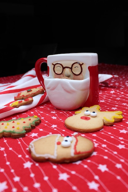 Santa Clausshaped mug with hot chocolate or coffee Christma's cookies peeks out of the cup