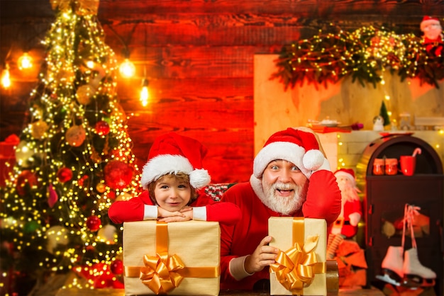 Santa helper and Santa Claus with Christmas gift