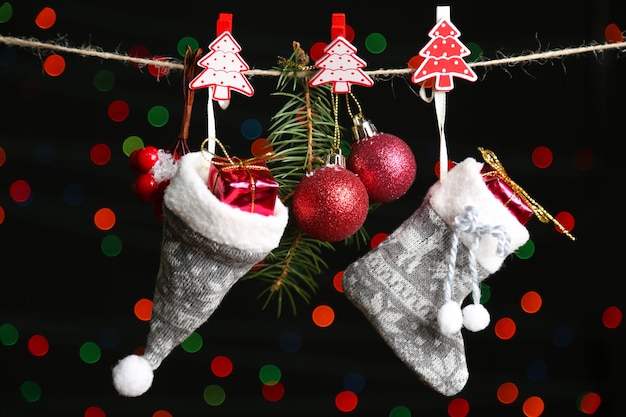 Santa sock, hat and Christmas accessories on black with lights