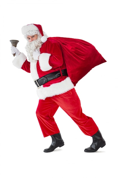 Photo santa walking with his sack and bell