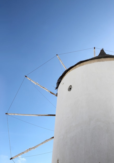 Santorini greek famous windmill on the bright blue sky. 