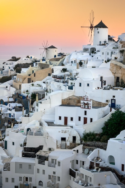 Santorini at Sundown The famous town of Oia in the sunset Traditional old windmills Romantic holidays Oia Santorini Greece