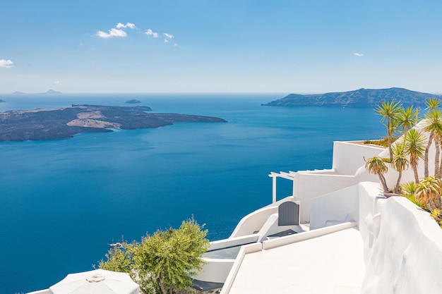 Santorini terrace and caldera view. Beautiful view of white architecture with flowers and blue sky,