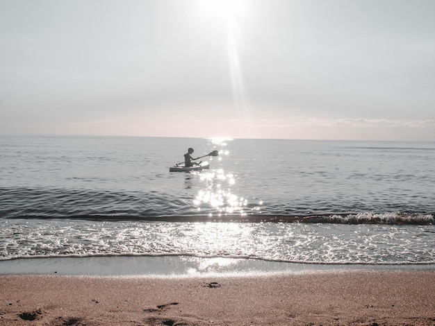 Sap surfer boy on the sea on a clear summer day