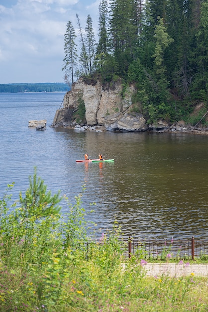 Sap surfers paddle the river along the cliffs and enjoy the view