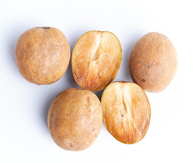 Sapodilla and fresh fruit isolated on a white background