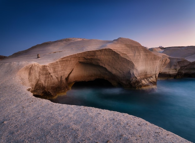 Sarakiniko beach Milos island Greece A seascape during sunset Long exposure Rocks on the seashore