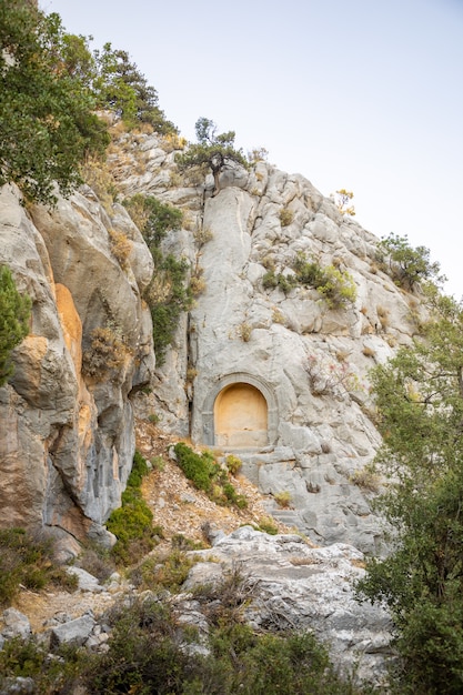 Sarcophagus or rock tombs in ruins of the ancient city of Termessos without tourists near Antalya in Turkey