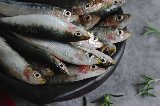 Sardines in a ceramic bowl on a marble table